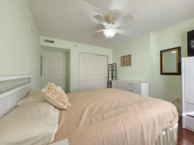 a bedroom with a bed and a chandelier