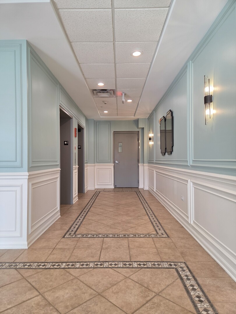 6815 North Milwaukee Avenue, Unit 210 Niles, IL 60714 - Photo 9 of 47 a view of a hallway with closet and chandelier