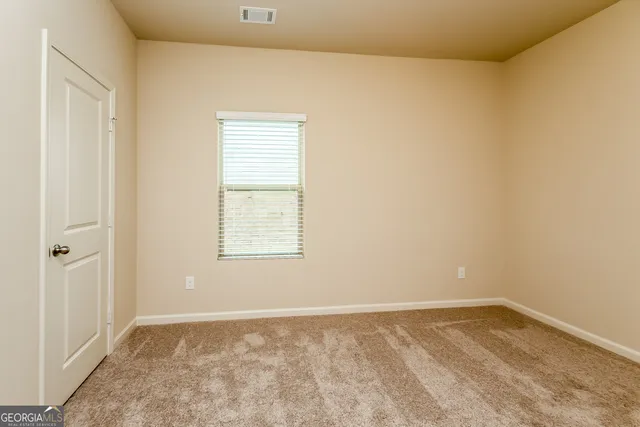 a view of an empty room and window