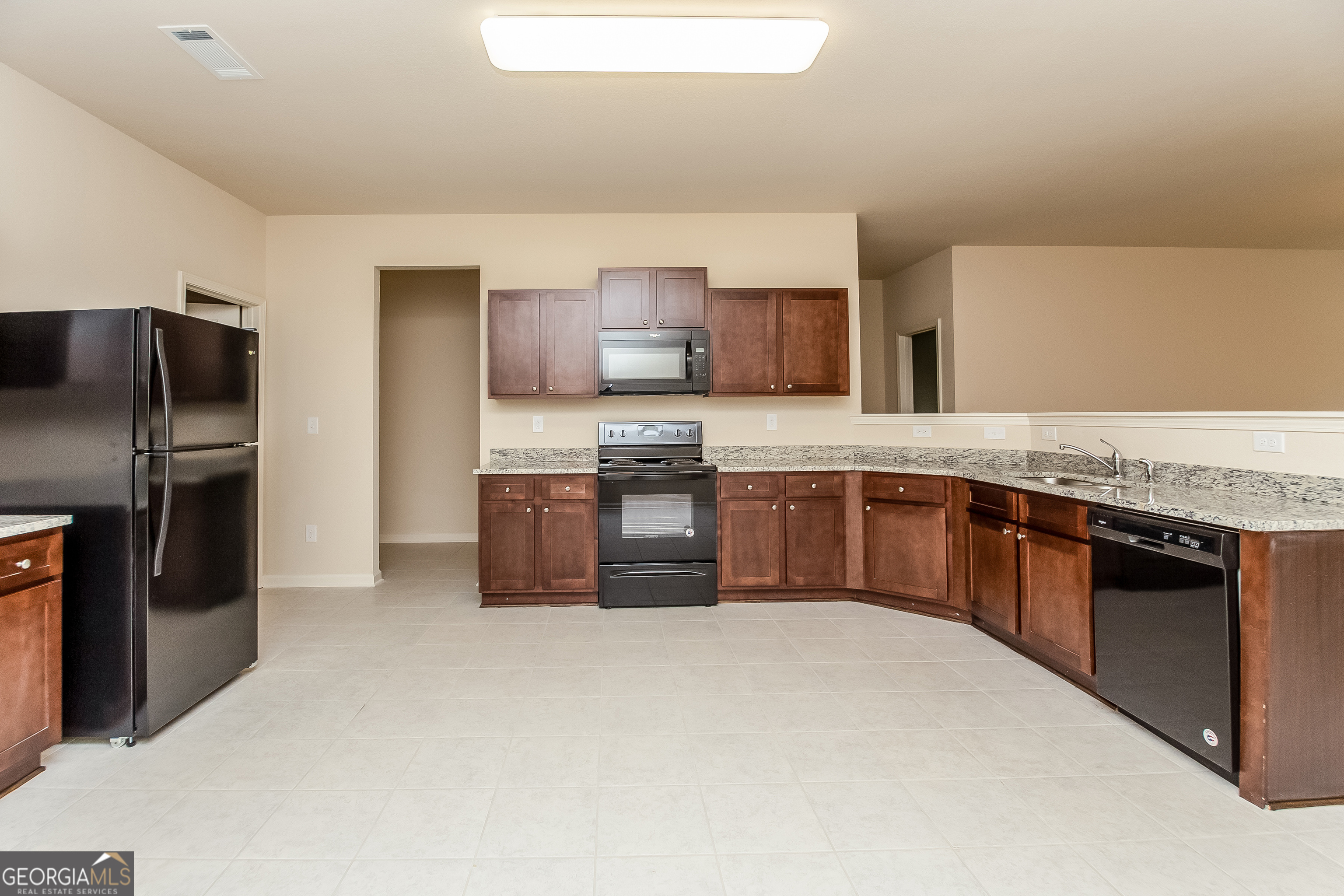 30 Olivia Way Covington, GA 30016 - Photo 5 of 15 a kitchen with stainless steel appliances granite countertop a stove a sink dishwasher a refrigerator and a oven