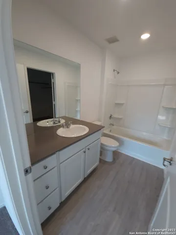 a bathroom with a double vanity sink toilet and mirror
