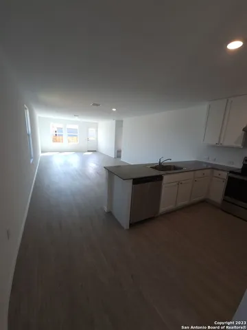 a view of a kitchen with an empty space and a window