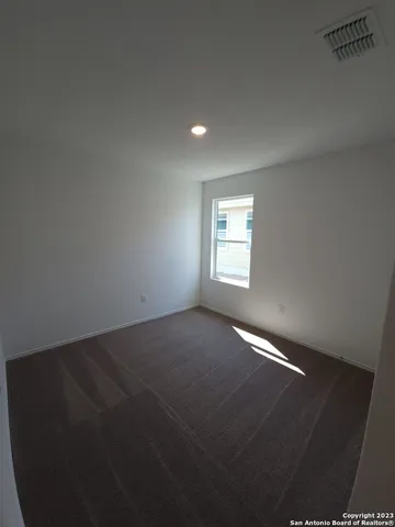 a view of an empty room and a window