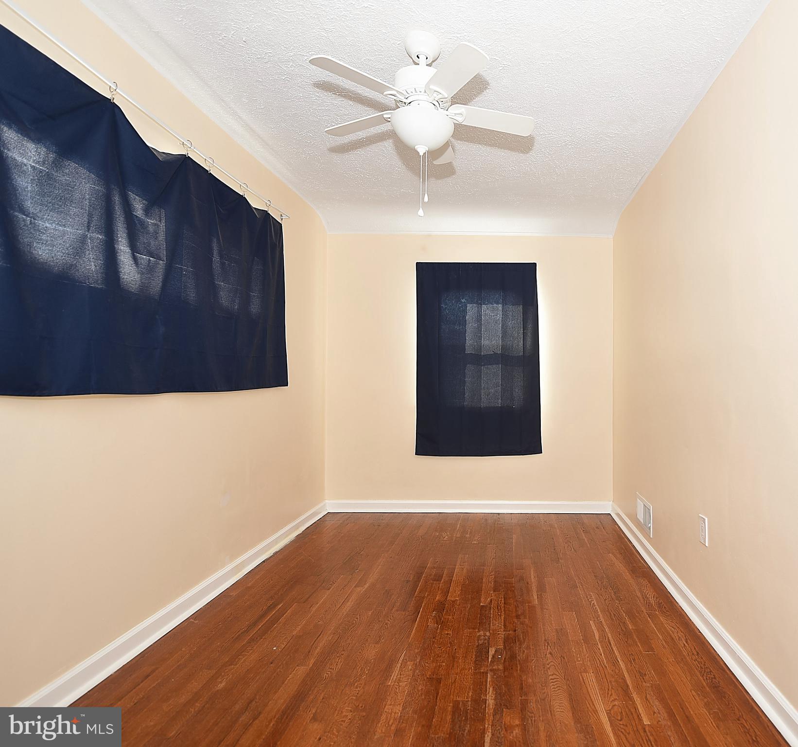 4423 Fenor Road Baltimore, MD 21227 - Photo 20 of 28 a view of an empty room with wooden floor