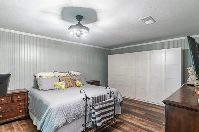 a bedroom with a bed and a chandelier