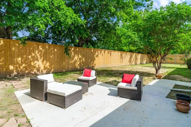 a backyard of a house with fire pit and outdoor seating