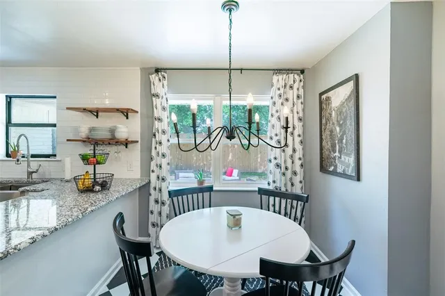 a dining room with furniture and window