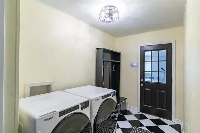 a utility room with a refrigerator and a sink