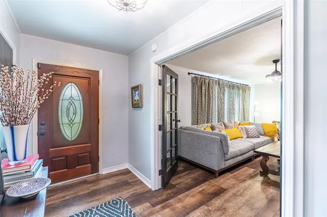 a living room with furniture a rug a toilet and a window