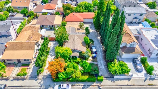 an aerial view of residential houses with plants and palm trees