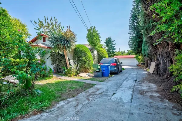 a couple of cars parked in front of a house