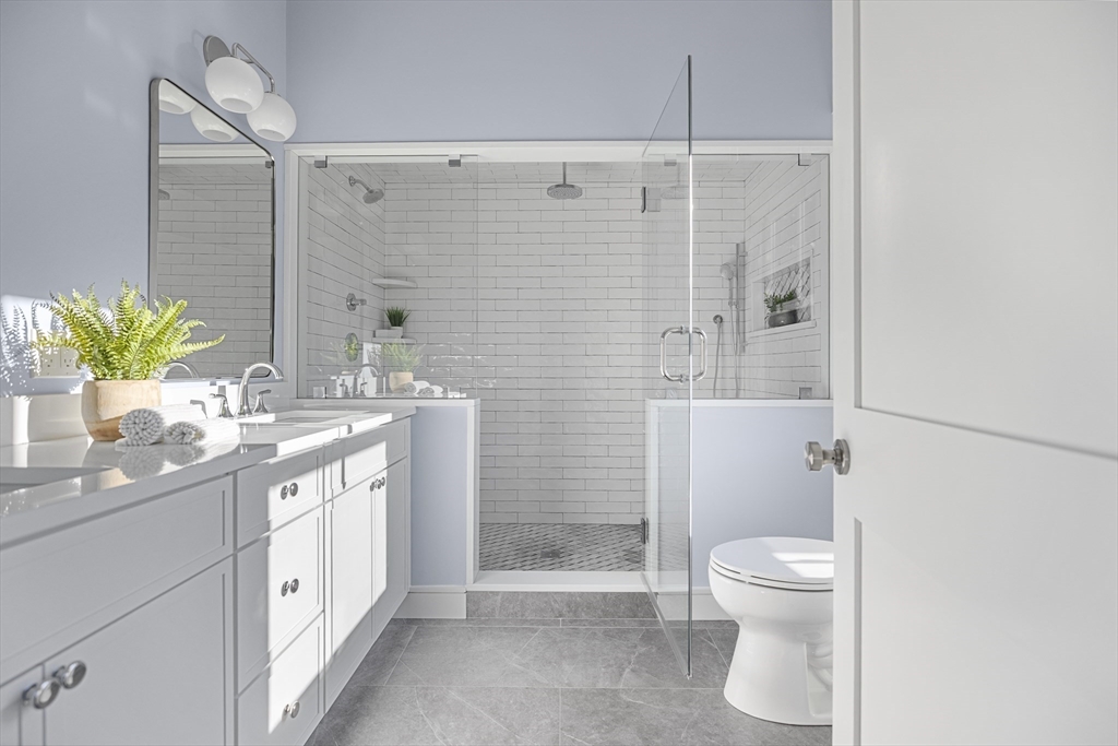 2 Howard Court Woburn, MA 01801 - Photo 18 of 37 a bathroom with a double vanity sink toilet and shower