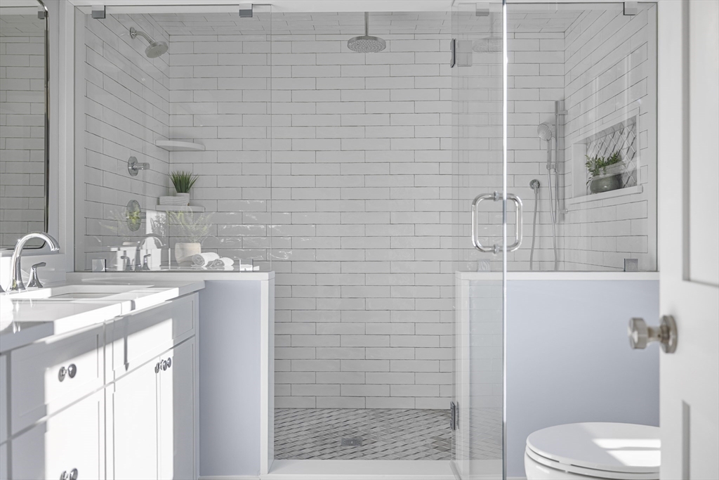 2 Howard Court Woburn, MA 01801 - Photo 19 of 37 a bathroom with a granite countertop toilet sink and shower