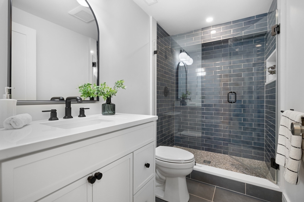 2 Howard Court Woburn, MA 01801 - Photo 22 of 37 a bathroom with a sink a toilet and shower