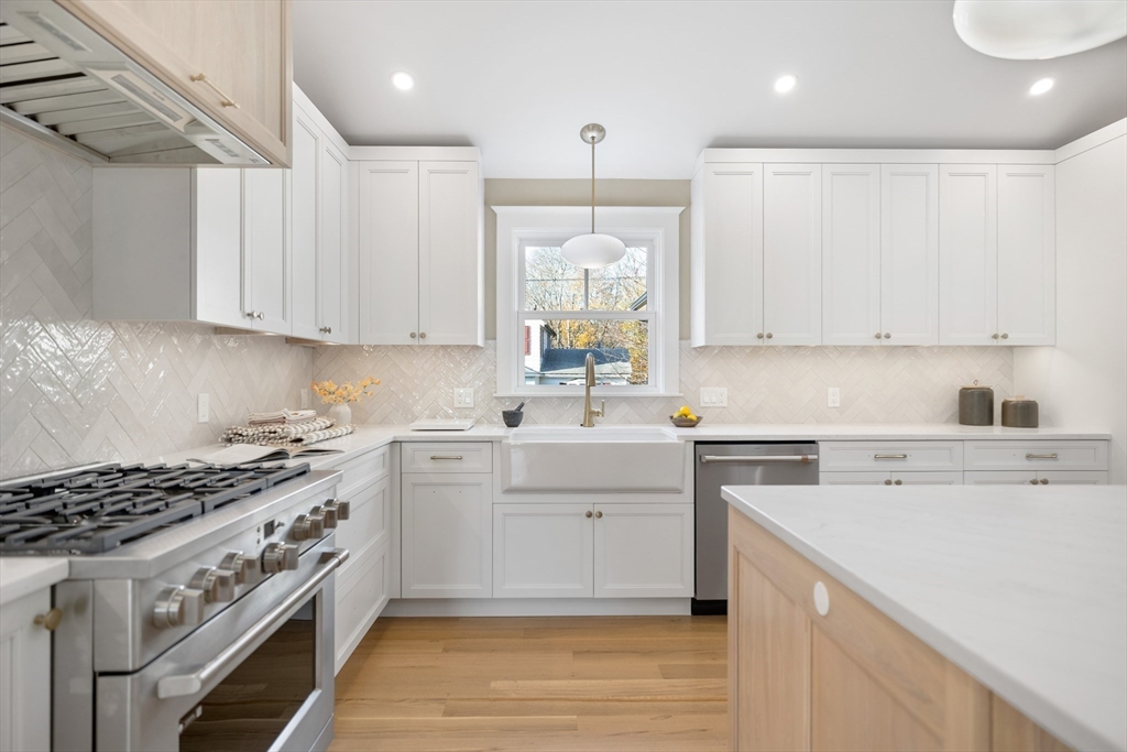 2 Howard Court Woburn, MA 01801 - Photo 8 of 37 a kitchen with a stove a sink and a refrigerator