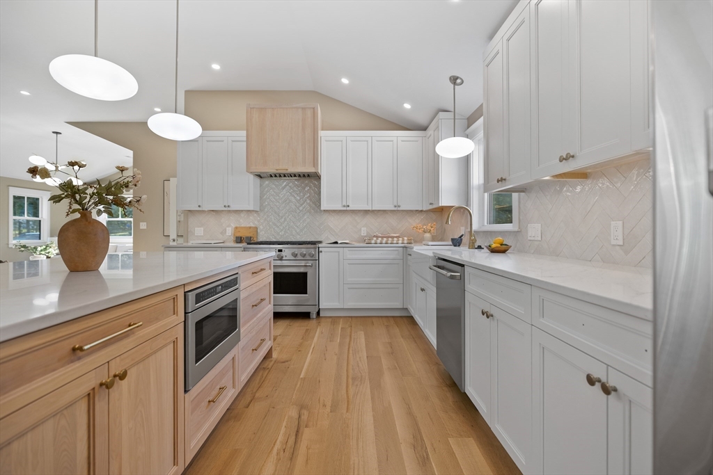 2 Howard Court Woburn, MA 01801 - Photo 9 of 37 a kitchen with a sink a counter top space stainless steel appliances and cabinets