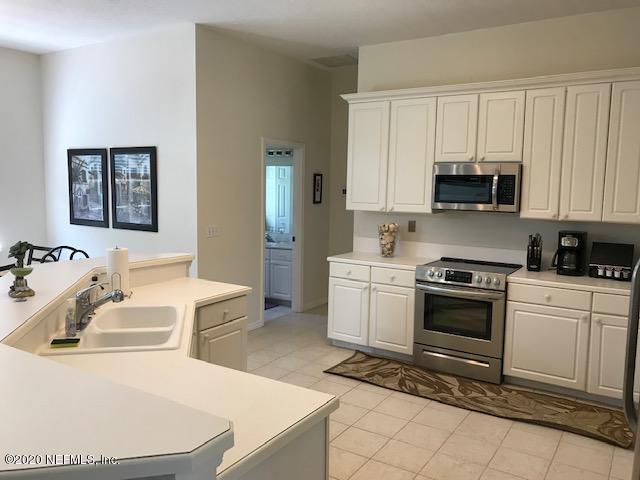 301 Twenty Second Street St. Augustine, FL 32084 - Photo 11 of 25 a kitchen with a sink a stove and cabinets