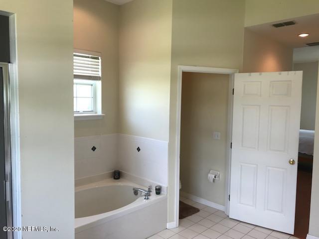 301 Twenty Second Street St. Augustine, FL 32084 - Photo 17 of 25 a bathroom with a bathtub and shower