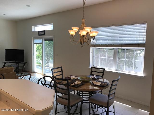 301 Twenty Second Street St. Augustine, FL 32084 - Photo 9 of 25 a view of a dining room with furniture a chandelier and window