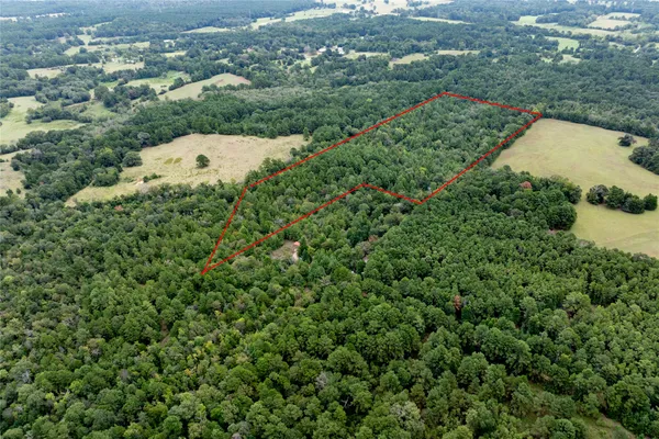an aerial view of a houses with a yard