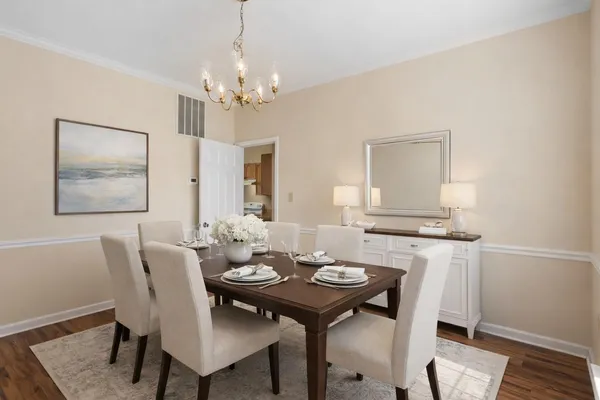 a view of a dining room with furniture and wooden floor