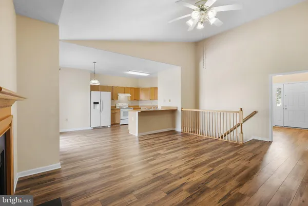 a view of a livingroom with a furniture wooden floor and staircase