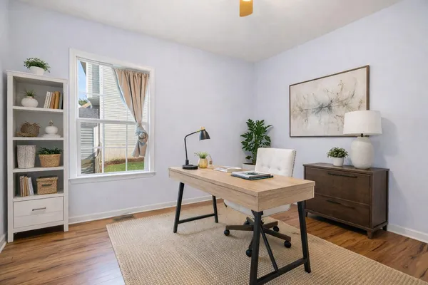 a view of a workspace with furniture and a potted plant
