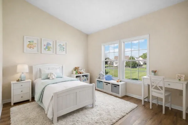 a room with a bed a large mirror and a large window with balcony view