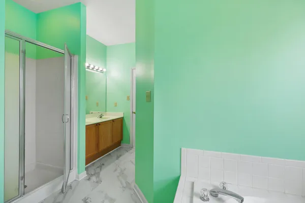 a bathroom with a bathtub sink and mirror