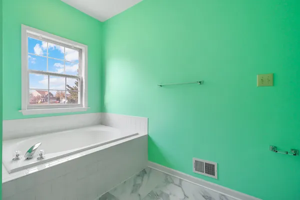 a bathroom with a bathtub and a sink