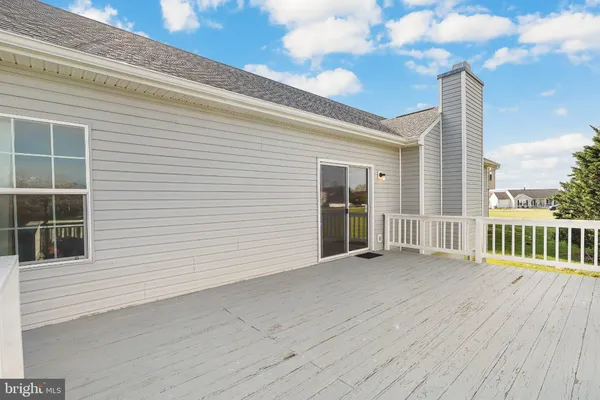 a view of a deck with wooden floor and fence