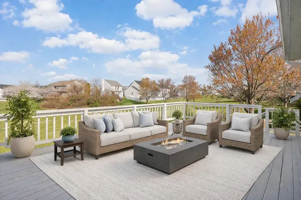 a roof deck with couches and city view