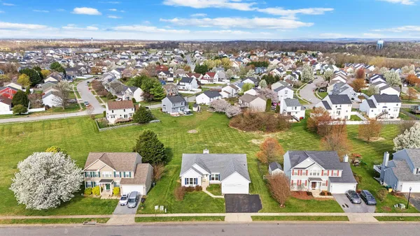 an aerial view of residential houses with outdoor space