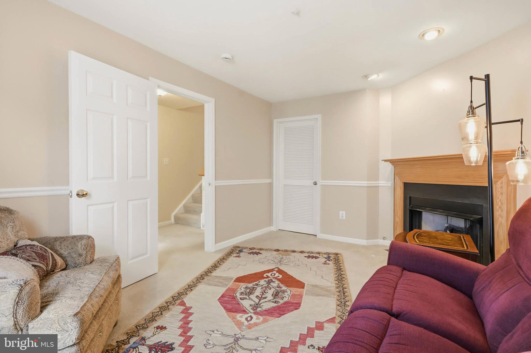 8721 Spring Brook Way Odenton, MD 21113 - Photo 18 of 40 a living room with furniture and a fireplace