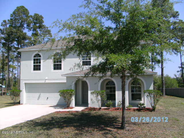 87242 Lents Road Yulee, FL 32097 - Photo 1 of 6 a front view of a house with garden