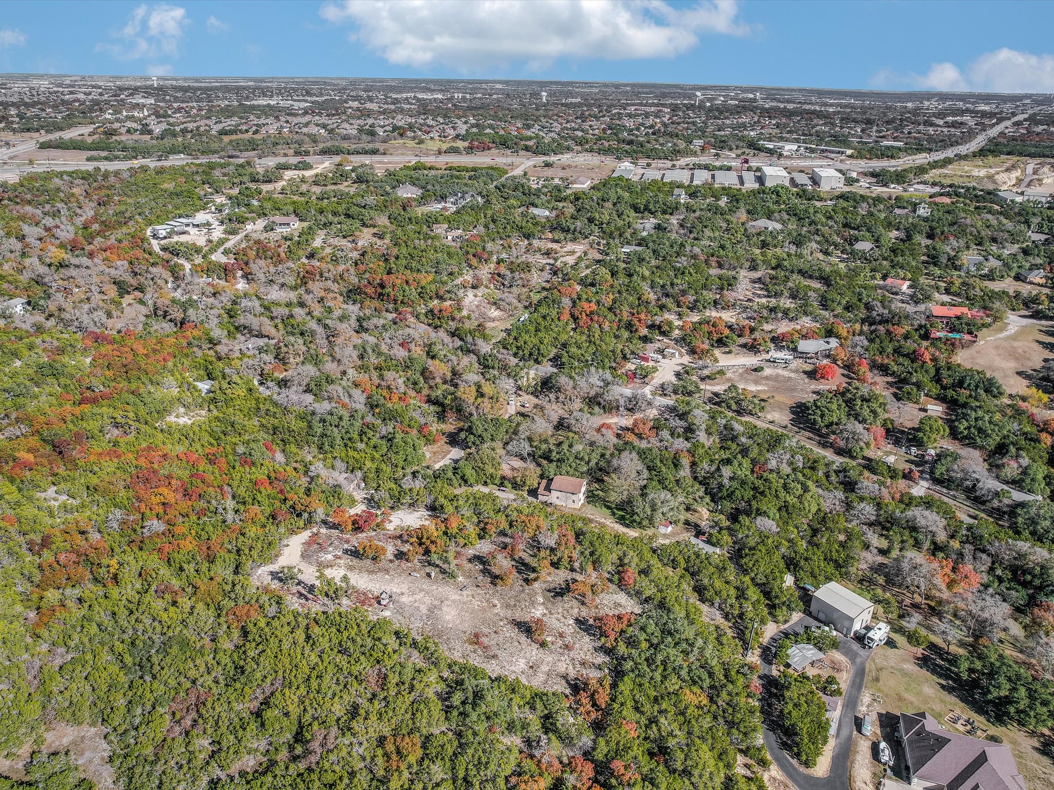 13404 Cedar Lime Road Leander, TX 78641 - Photo 11 of 28 Discover vast, undeveloped land with scattered homes and a natural, verdant landscape.