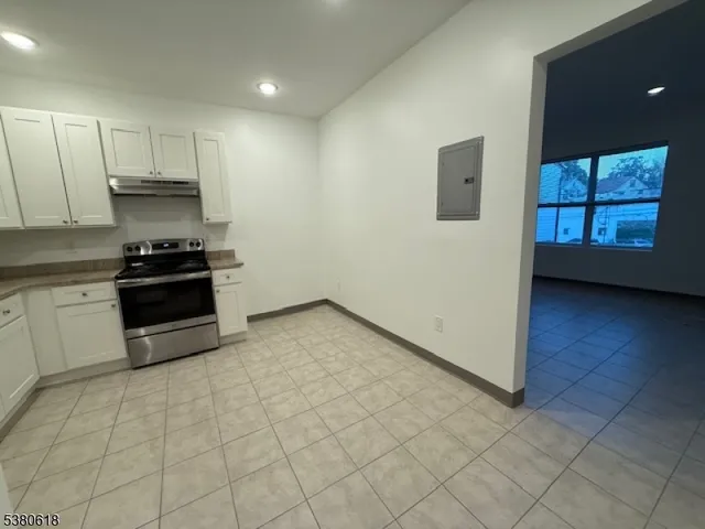 a kitchen with a sink a stove and cabinets
