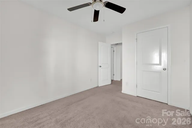 an empty room with ceiling fan
