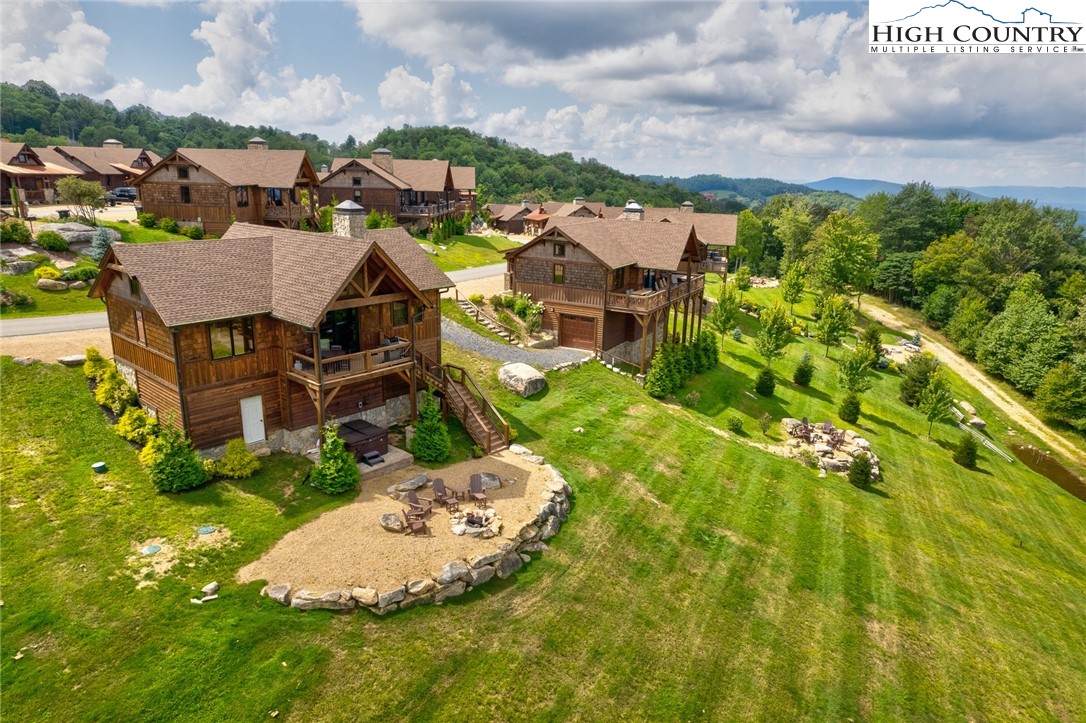 an aerial view of residential houses with outdoor space and trees