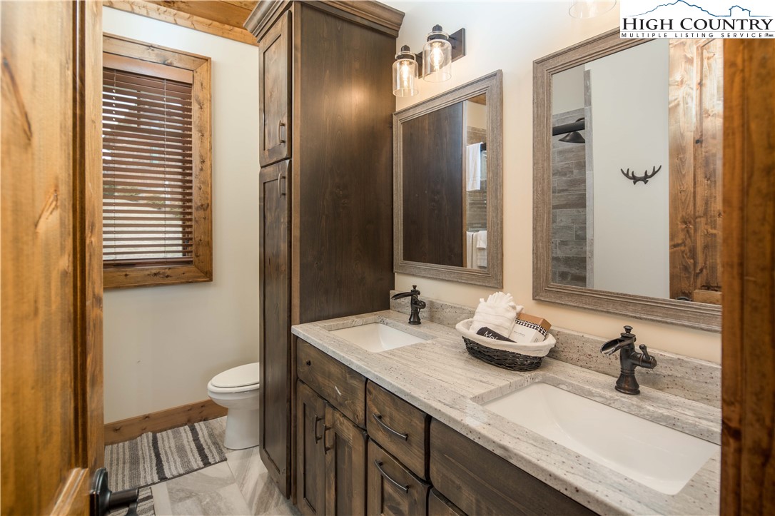 44 Camp Eagle Loop Banner Elk, NC 28604 - Photo 15 of 43 a bathroom with a granite countertop sink and a mirror