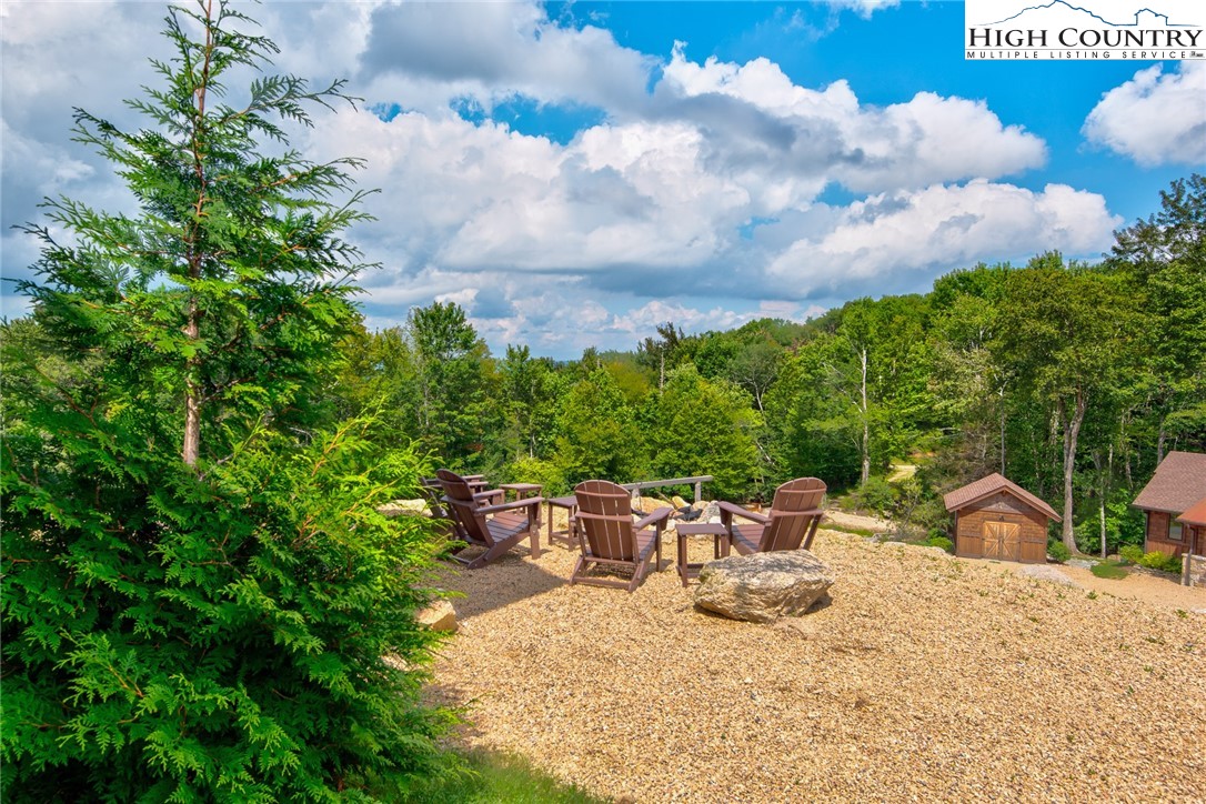 44 Camp Eagle Loop Banner Elk, NC 28604 - Photo 20 of 43 a view of a patio with table and chairs and potted plants