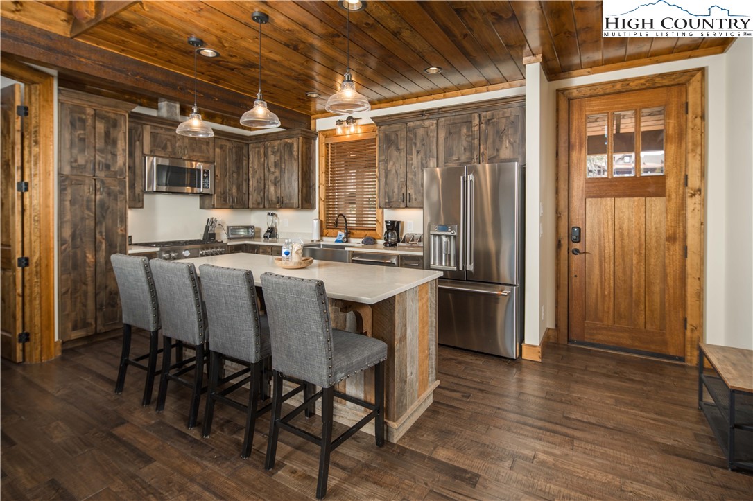 44 Camp Eagle Loop Banner Elk, NC 28604 - Photo 4 of 43 a kitchen with a table chairs refrigerator and cabinets