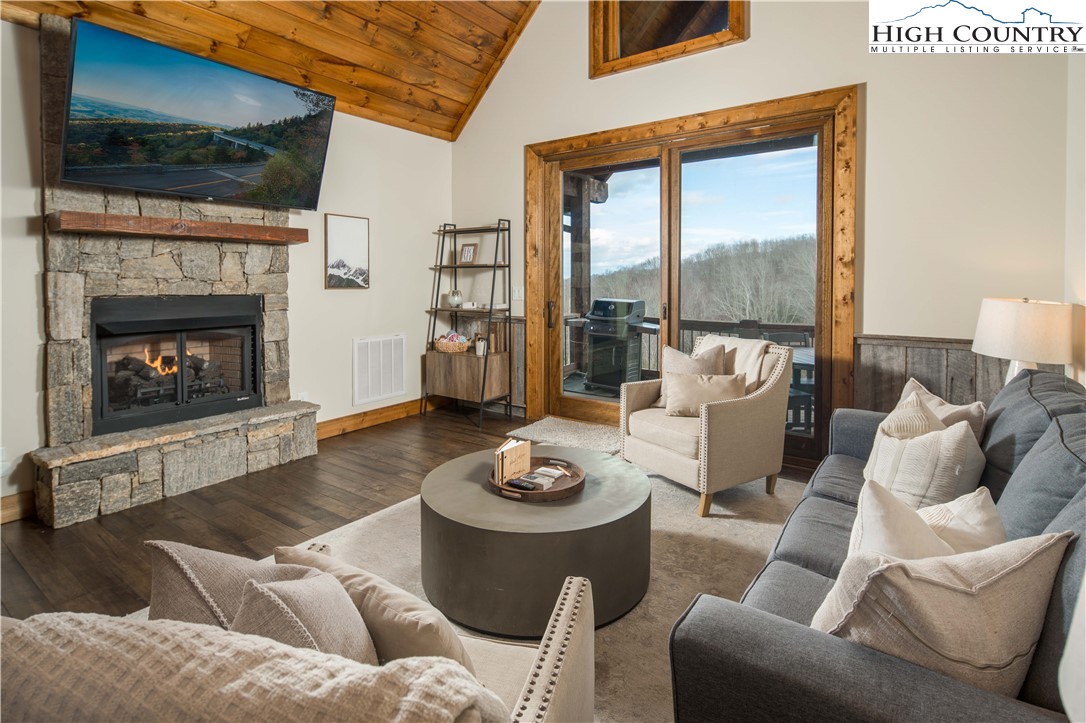 44 Camp Eagle Loop Banner Elk, NC 28604 - Photo 9 of 43 a living room with furniture a fireplace and a flat screen tv