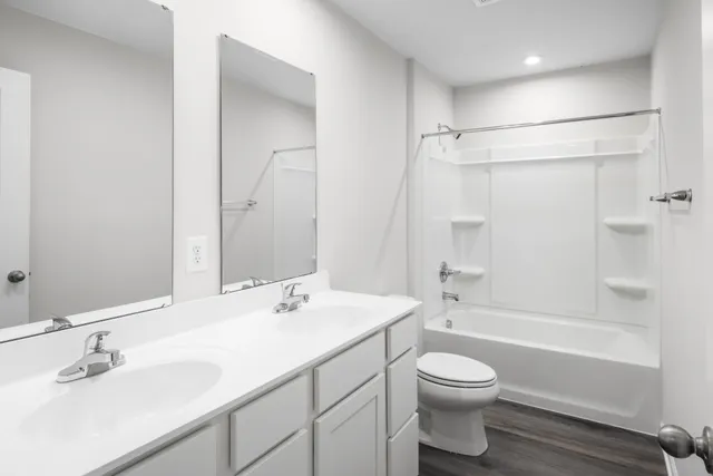 a bathroom with a sink a toilet and a bathtub