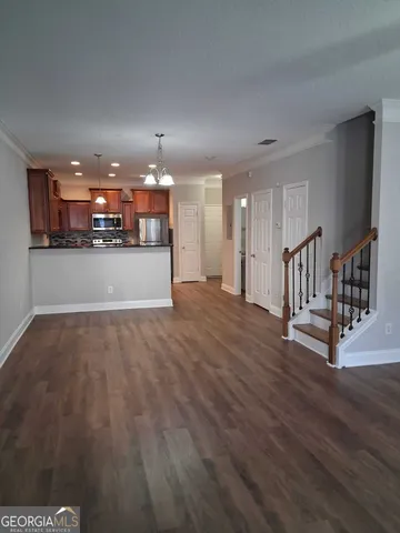 a view of a livingroom with kitchen and furniture