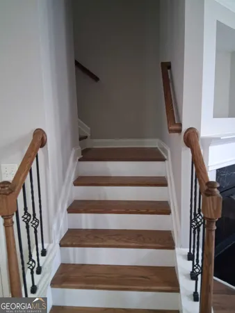 a view of staircase with wooden floor and windows