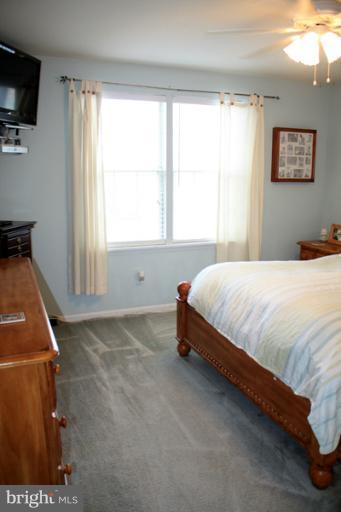 73 Haverhill Road Joppa, MD 21085 - Photo 3 of 30 a bedroom with a bed and a flat tv screen on the dresser