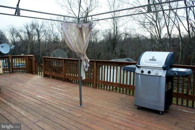 73 Haverhill Road Joppa, MD 21085 - Photo 7 of 30 a view of a balcony with wooden floor and fence