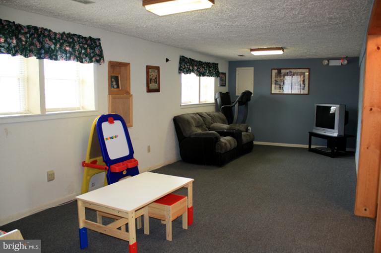 73 Haverhill Road Joppa, MD 21085 - Photo 10 of 30 a living room with furniture a flat screen tv and a window