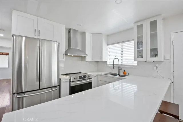 a kitchen with stainless steel appliances granite countertop a refrigerator sink and stove